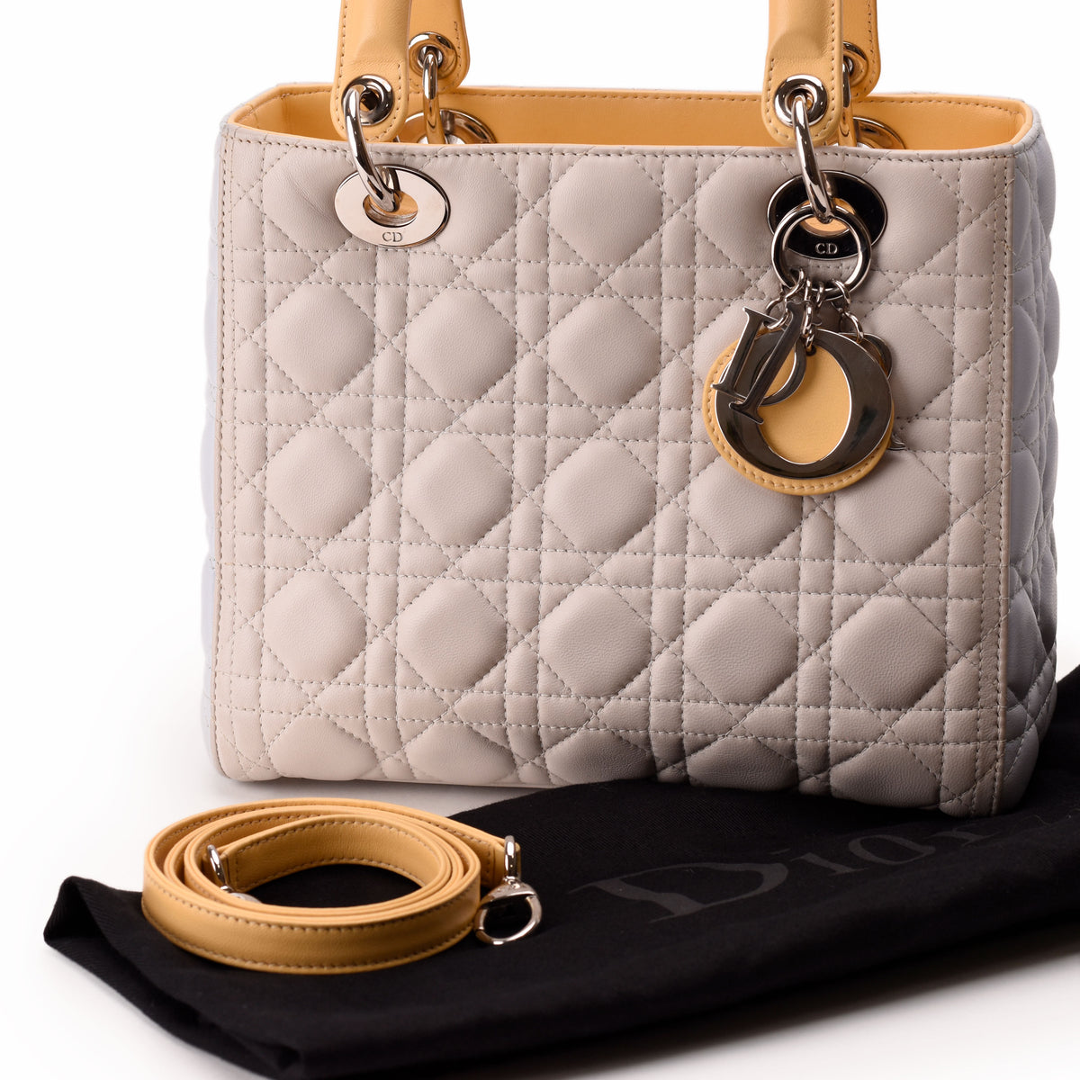 Grey quilted leather Christian Dior handbag with yellow handles and strap, curated Pre-loved Luxury by Myluxe in Helsinki.