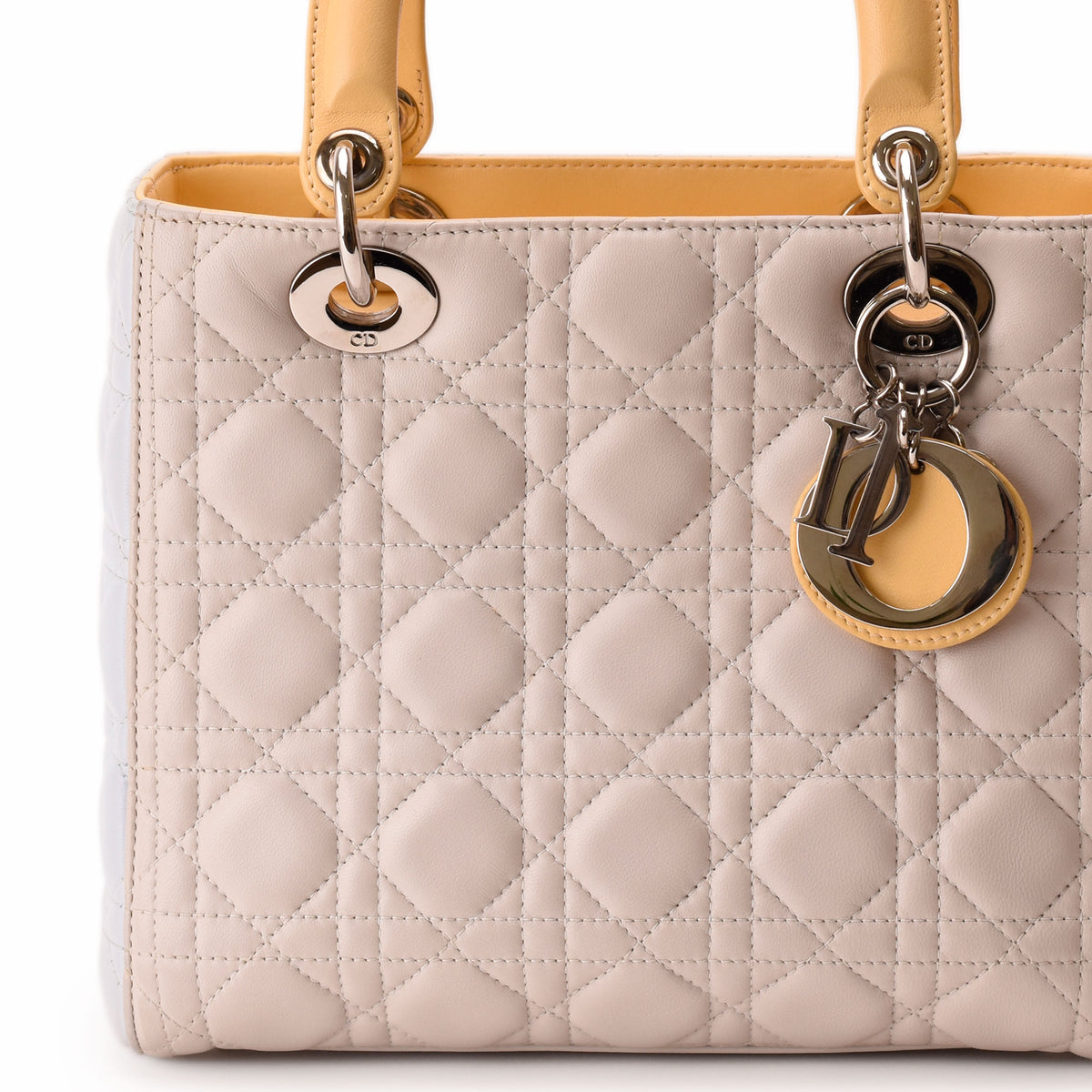 Pale pink quilted leather Dior handbag with gold-tone CD charms. curated Pre-loved Luxury by Myluxe in Helsinki.