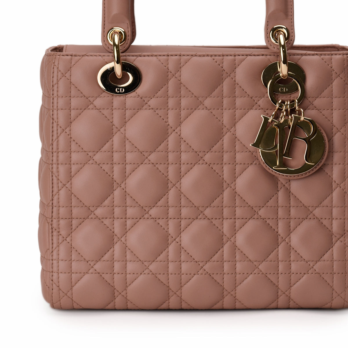 Dusty rose quilted leather Dior handbag with gold-tone charms, curated Pre-loved Luxury by Myluxe in Helsinki.