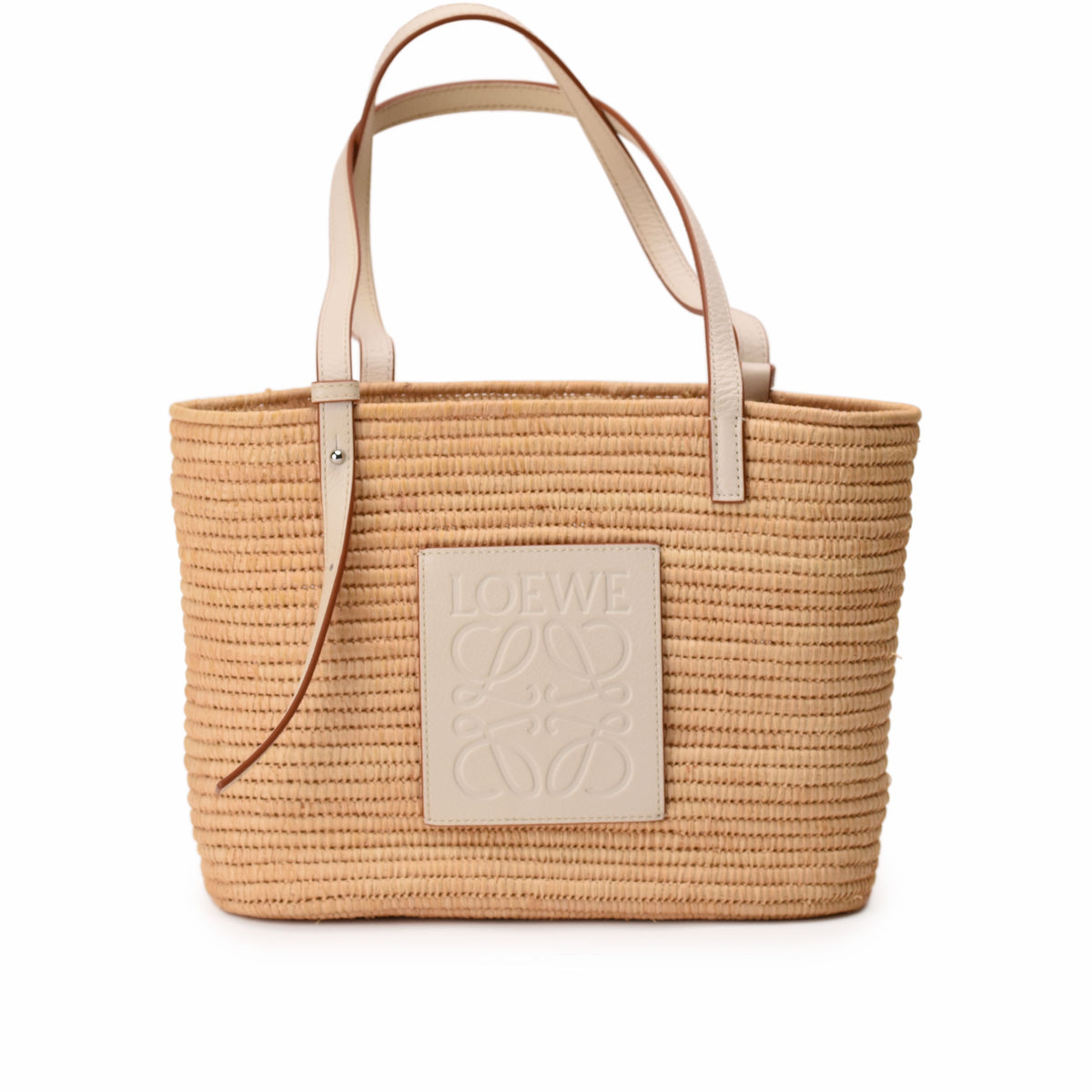 Beige woven straw Loewe basket bag with leather handles and logo patch. curated Pre-loved Luxury by Myluxe in Helsinki.