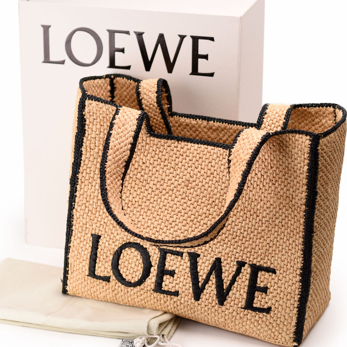 Loewe woven straw tote bag with black logo detail. curated Pre-loved Luxury by Myluxe in Helsinki.