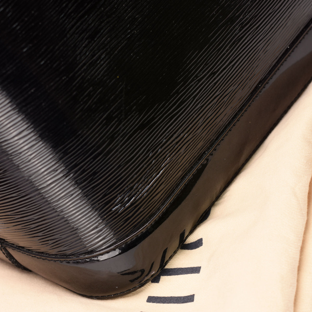 Black patent leather textured luxury handbag, curated Pre-loved Luxury by Myluxe in Helsinki.
