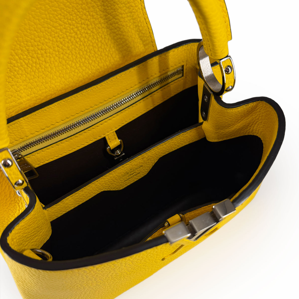 Interior view of a yellow pebbled leather luxury handbag with black lining, curated Pre-loved Luxury by Myluxe in Helsinki.