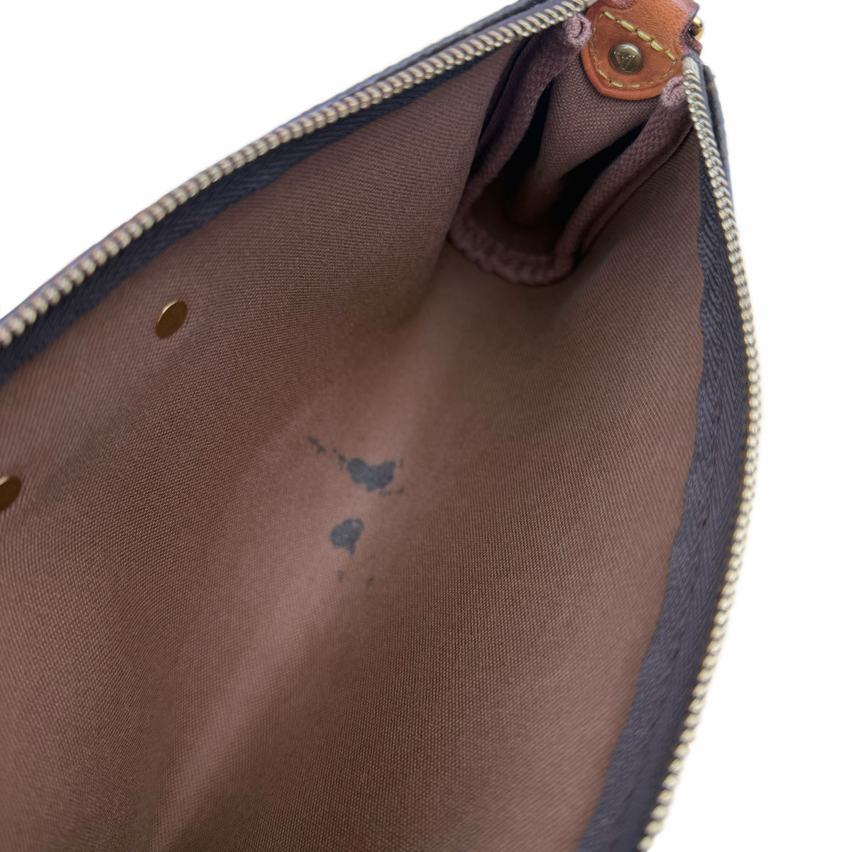 Interior of a Louis Vuitton handbag with brown fabric lining, curated Pre-loved Luxury by Myluxe in Helsinki.