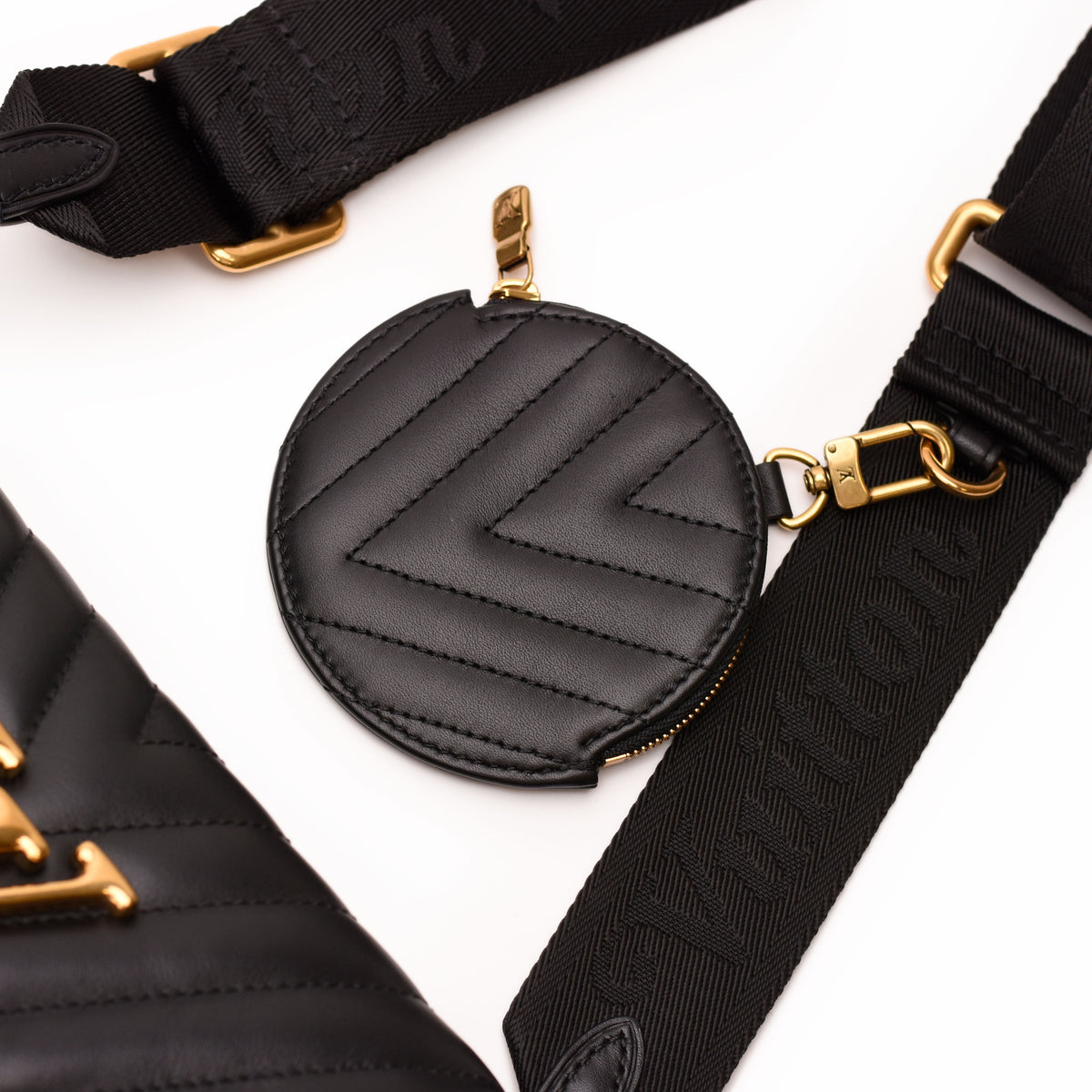 Black quilted leather Louis Vuitton round coin purse with gold-tone hardware. curated Pre-loved Luxury by Myluxe in Helsinki.