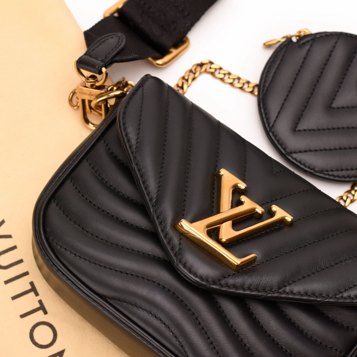 Black quilted leather Louis Vuitton crossbody bag with gold-tone LV logo. curated Pre-loved Luxury by Myluxe in Helsinki.