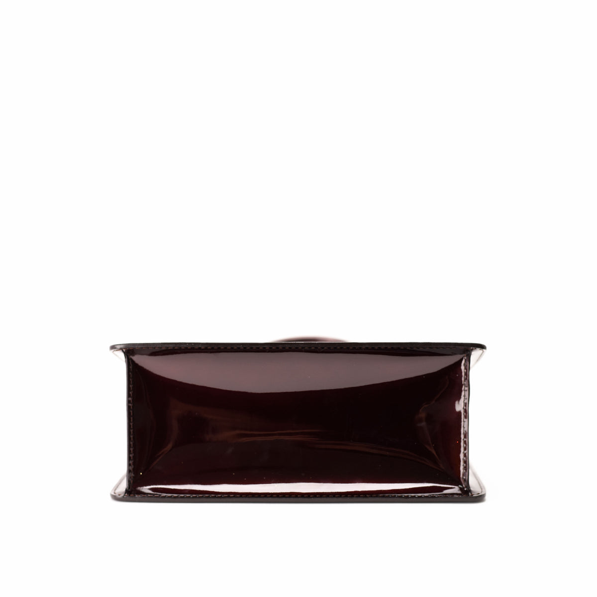 Interior view of a dark burgundy patent leather luxury handbag, curated Pre-loved Luxury by Myluxe in Helsinki.