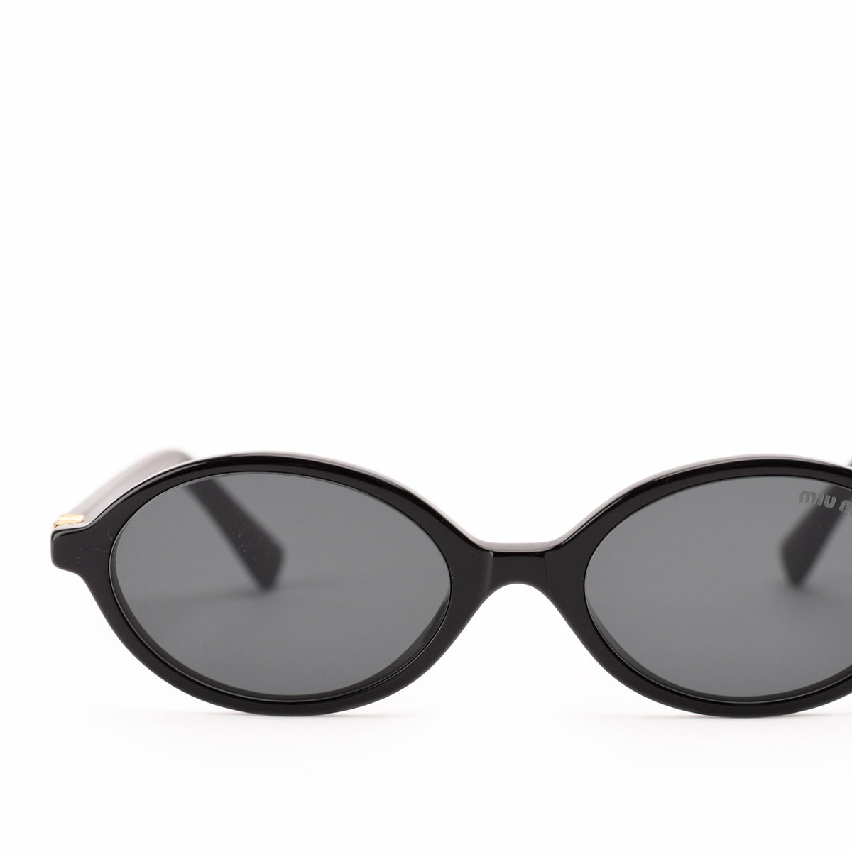 Black oval-shaped luxury sunglasses with dark tinted lenses. curated Pre-loved Luxury by Myluxe in Helsinki.