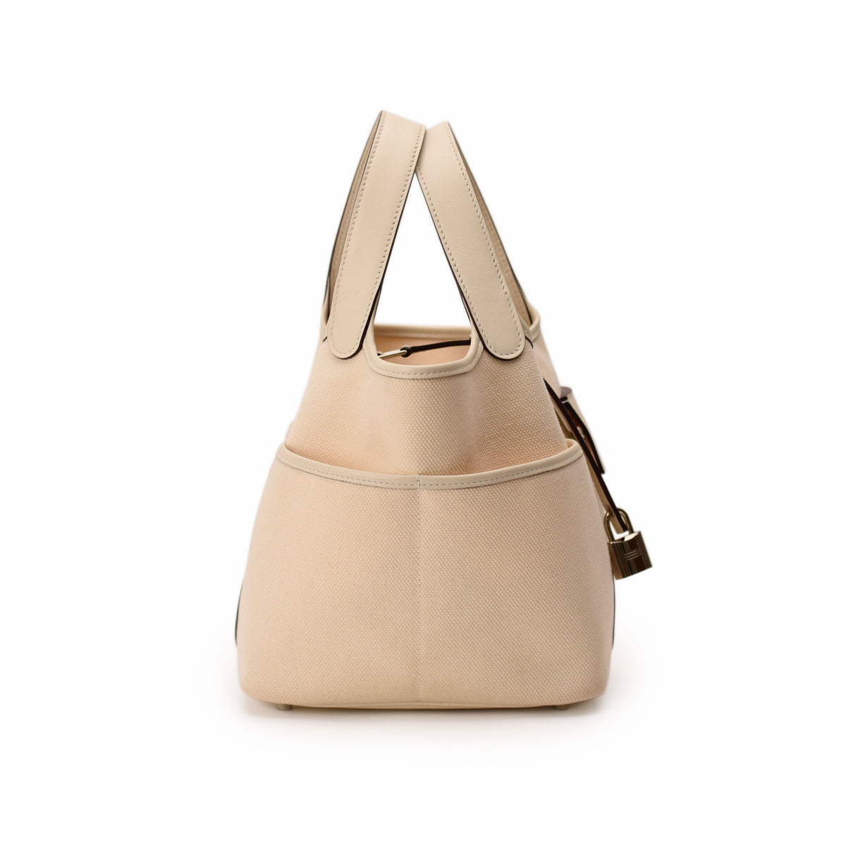 Cream beige canvas tote bag with leather handles and gold hardware. curated Pre-loved Luxury by Myluxe in Helsinki.