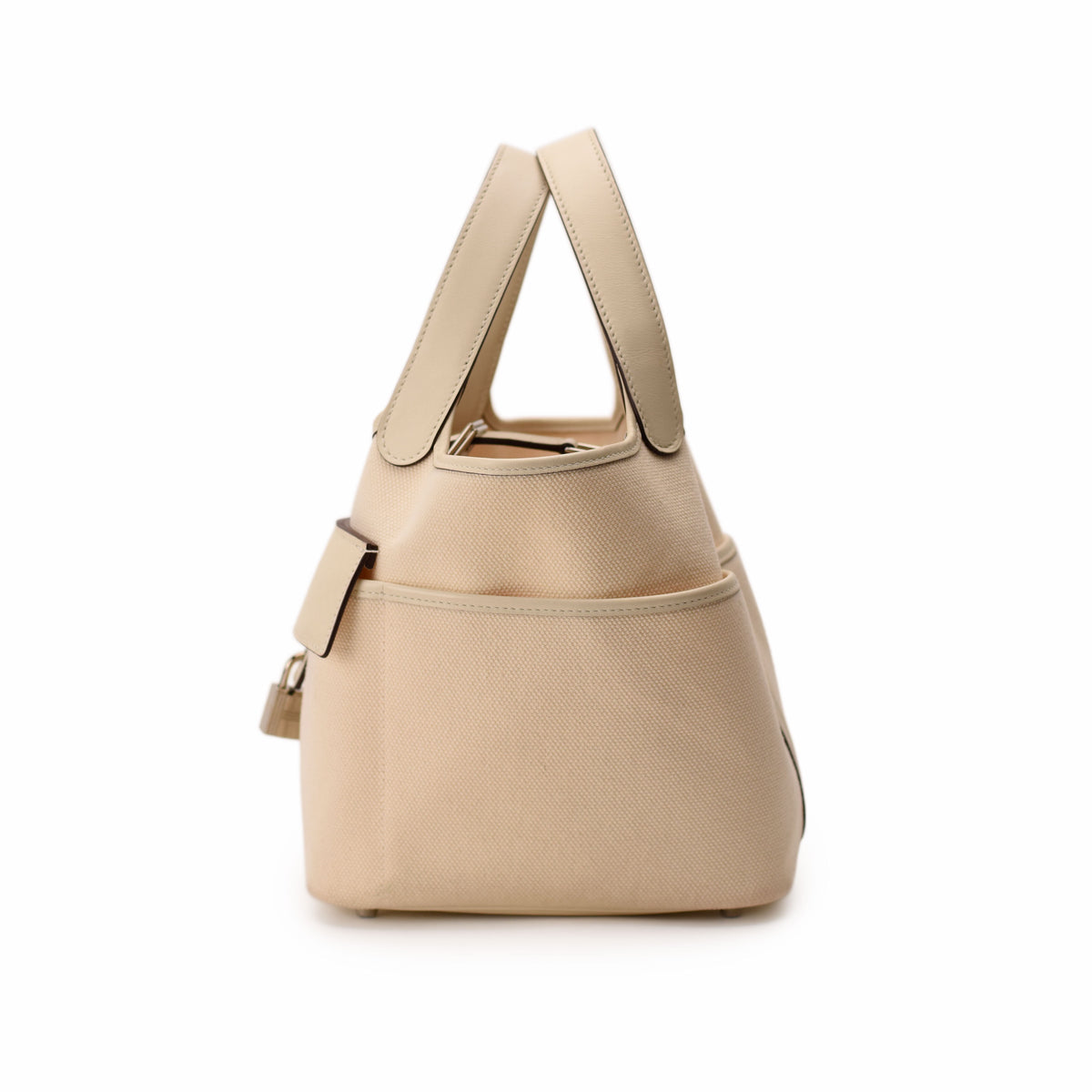Beige canvas tote bag with leather handles and side pocket. curated Pre-loved Luxury by Myluxe in Helsinki.