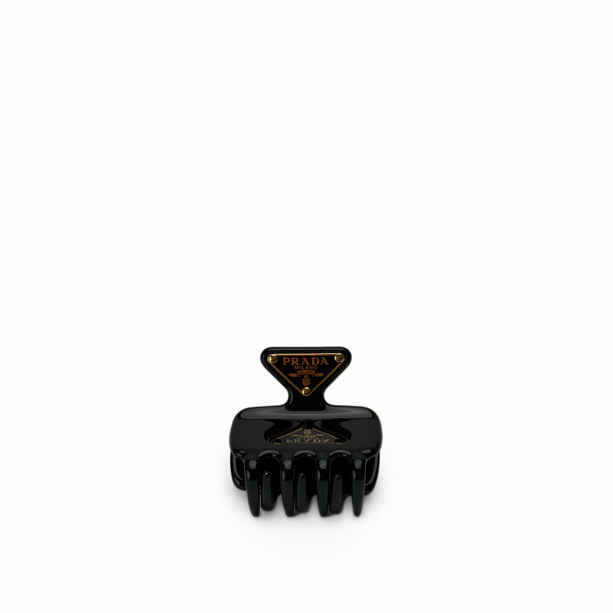 Black Prada Milano hair claw clip with gold logo detailing, curated Pre-loved Luxury by Myluxe in Helsinki.