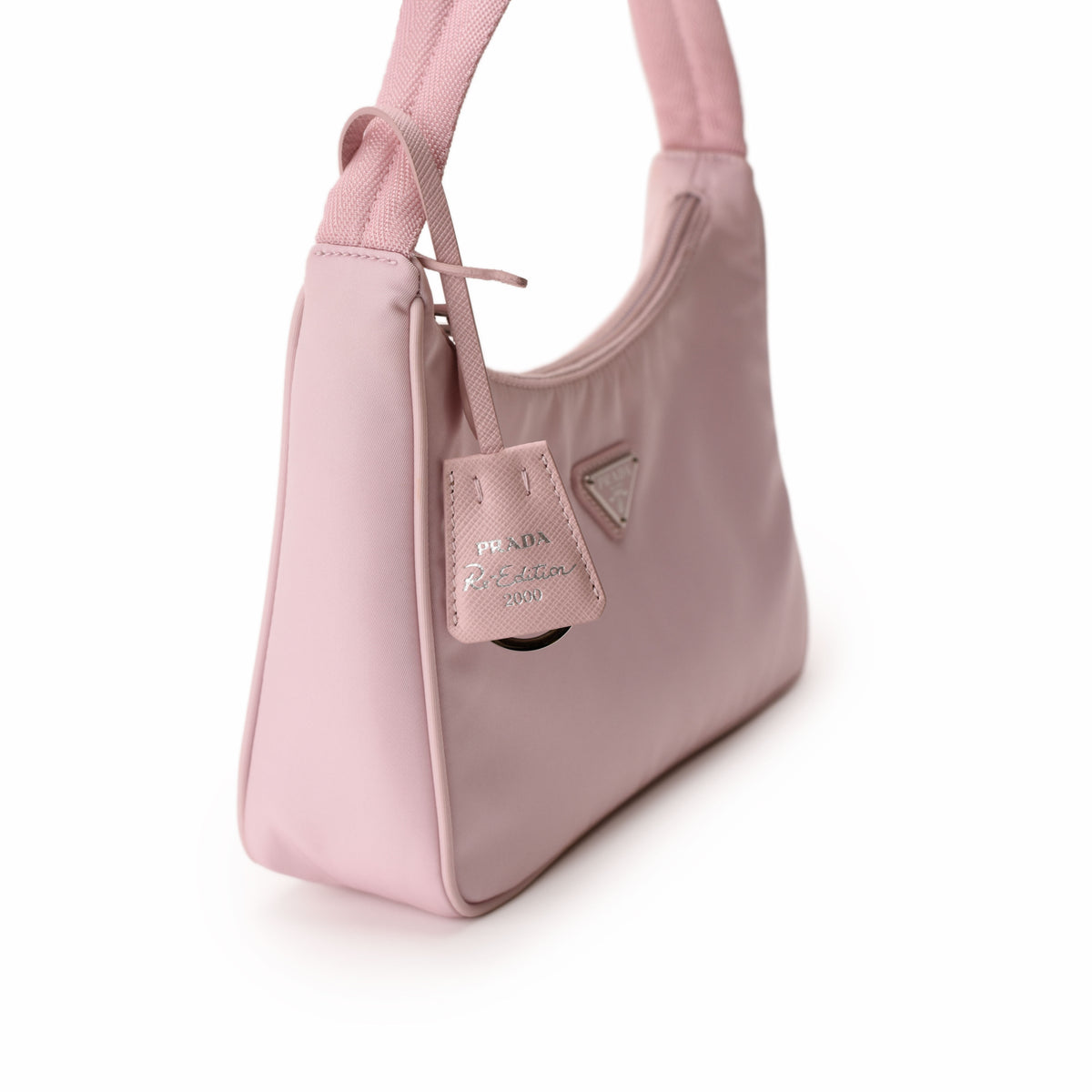 Pink Prada Re-Edition nylon shoulder bag with silver logo charm. curated Pre-loved Luxury by Myluxe in Helsinki.