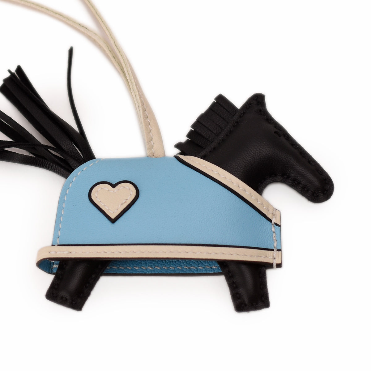 Light blue leather horse charm with white heart detail. curated Pre-loved Luxury by Myluxe in Helsinki.