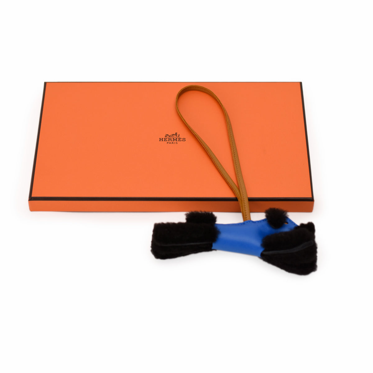 Hermès blue leather accessory with black fur trim. curated Pre-loved Luxury by Myluxe in Helsinki.
