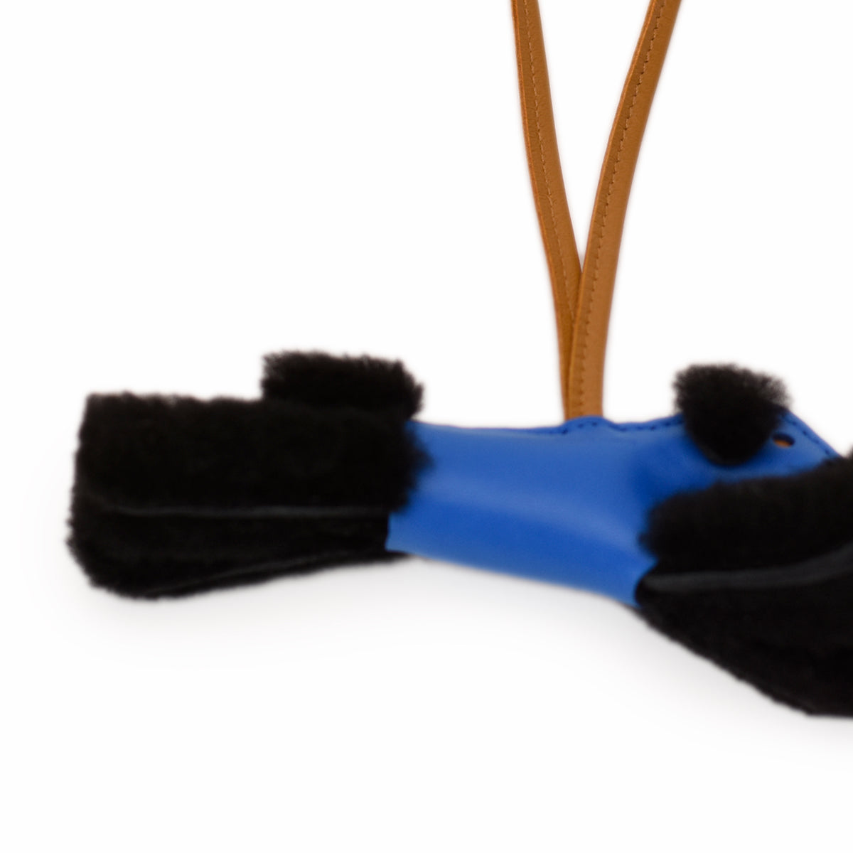 Blue leather accessory with black faux fur trim. Curated Pre-loved Luxury by Myluxe in Helsinki.