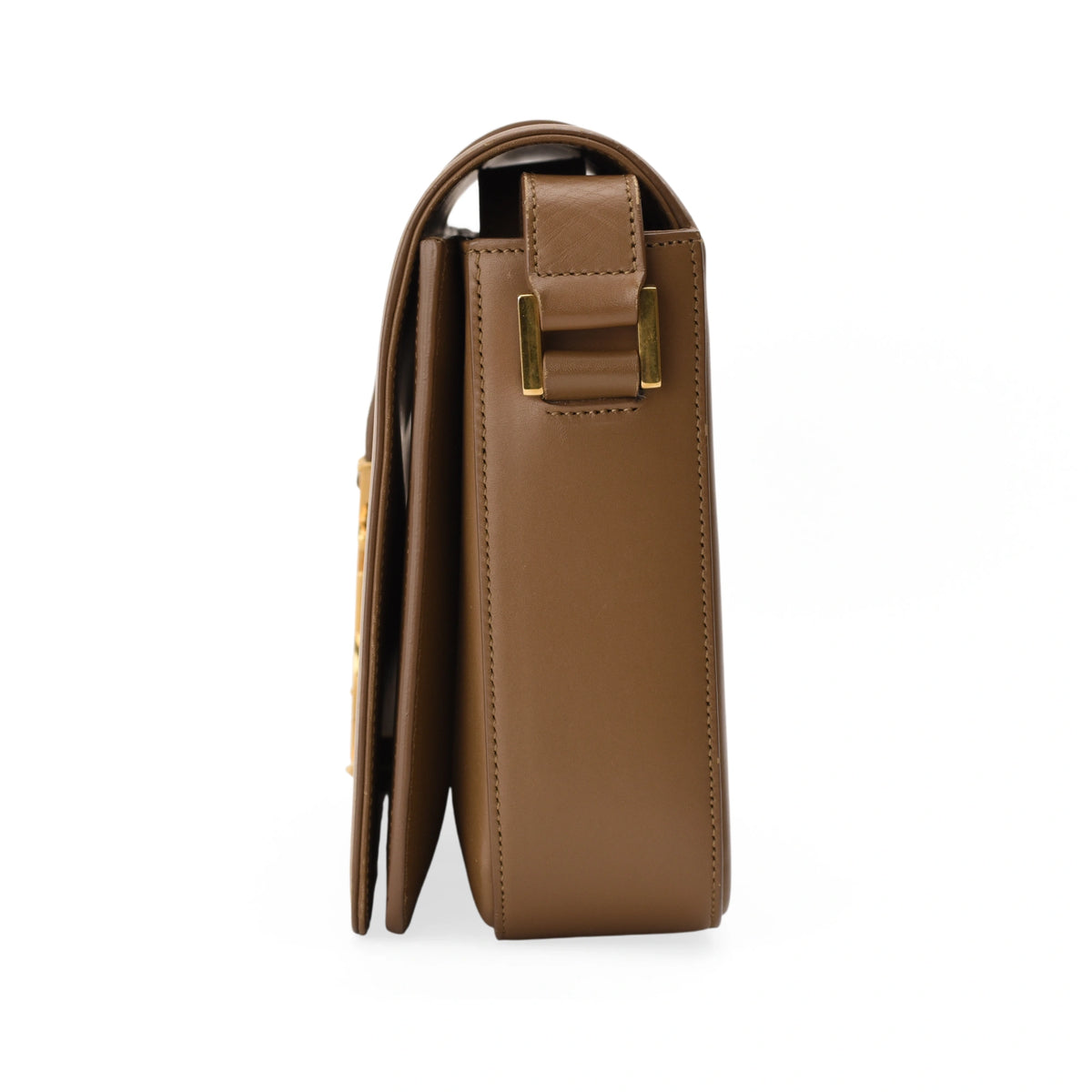 Side view of a brown leather Chanel handbag with gold hardware. curated Pre-loved Luxury by Myluxe in Helsinki.