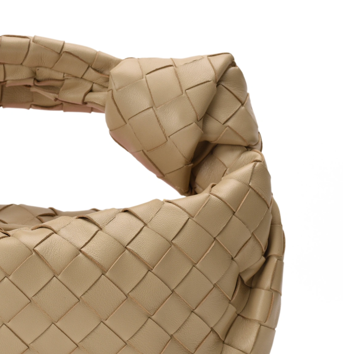 Close-up of a beige woven leather Bottega Veneta handbag, curated Pre-loved Luxury by Myluxe in Helsinki.