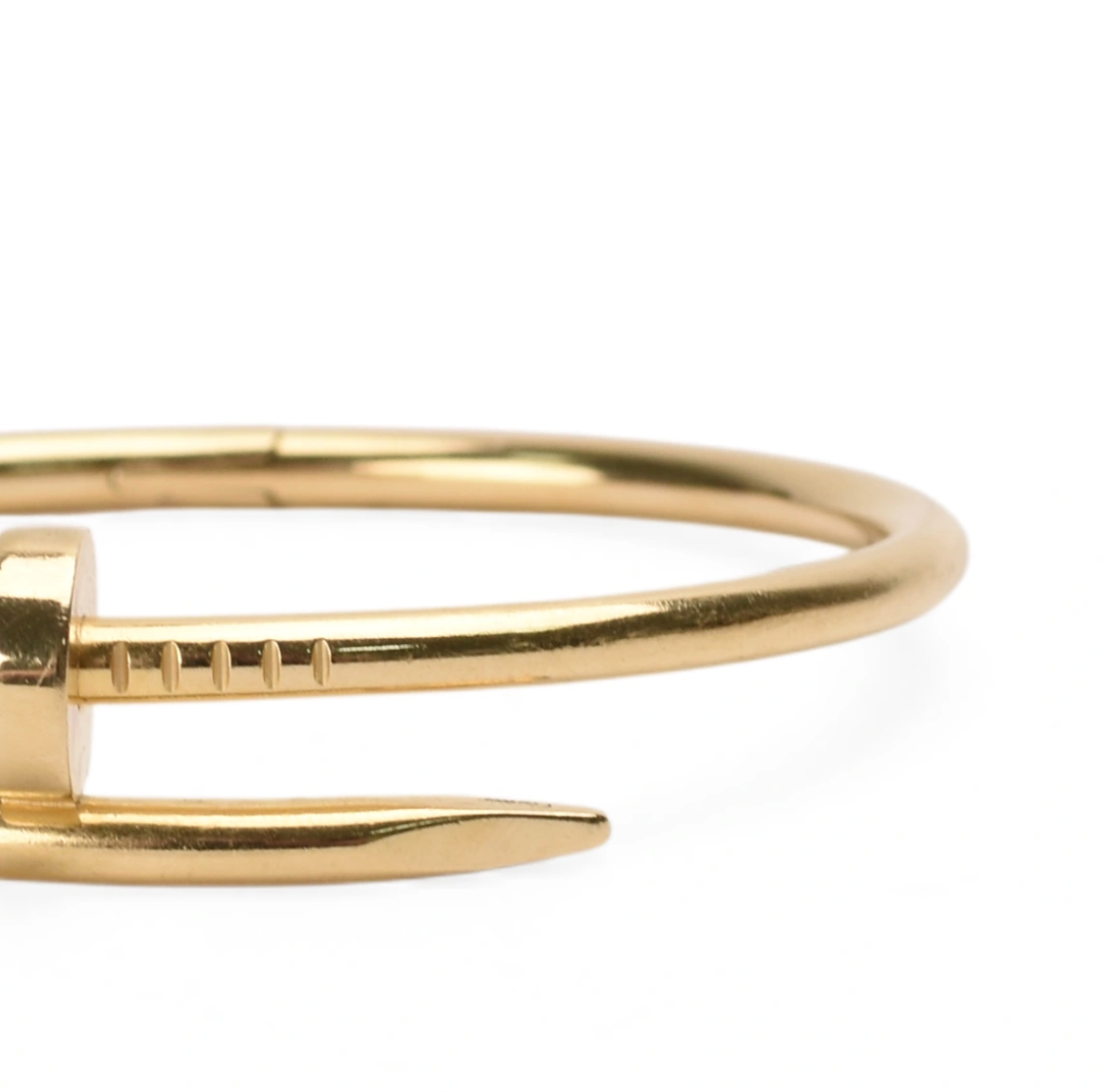 Close-up of a gold-toned luxury bangle with a screw detail, curated Pre-loved Luxury by Myluxe in Helsinki.