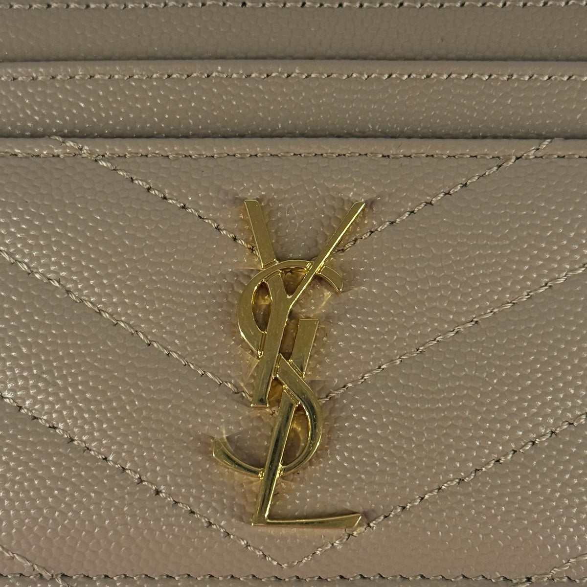 Gold-tone YSL logo on beige pebbled leather, curated Pre-loved Luxury by Myluxe in Helsinki.