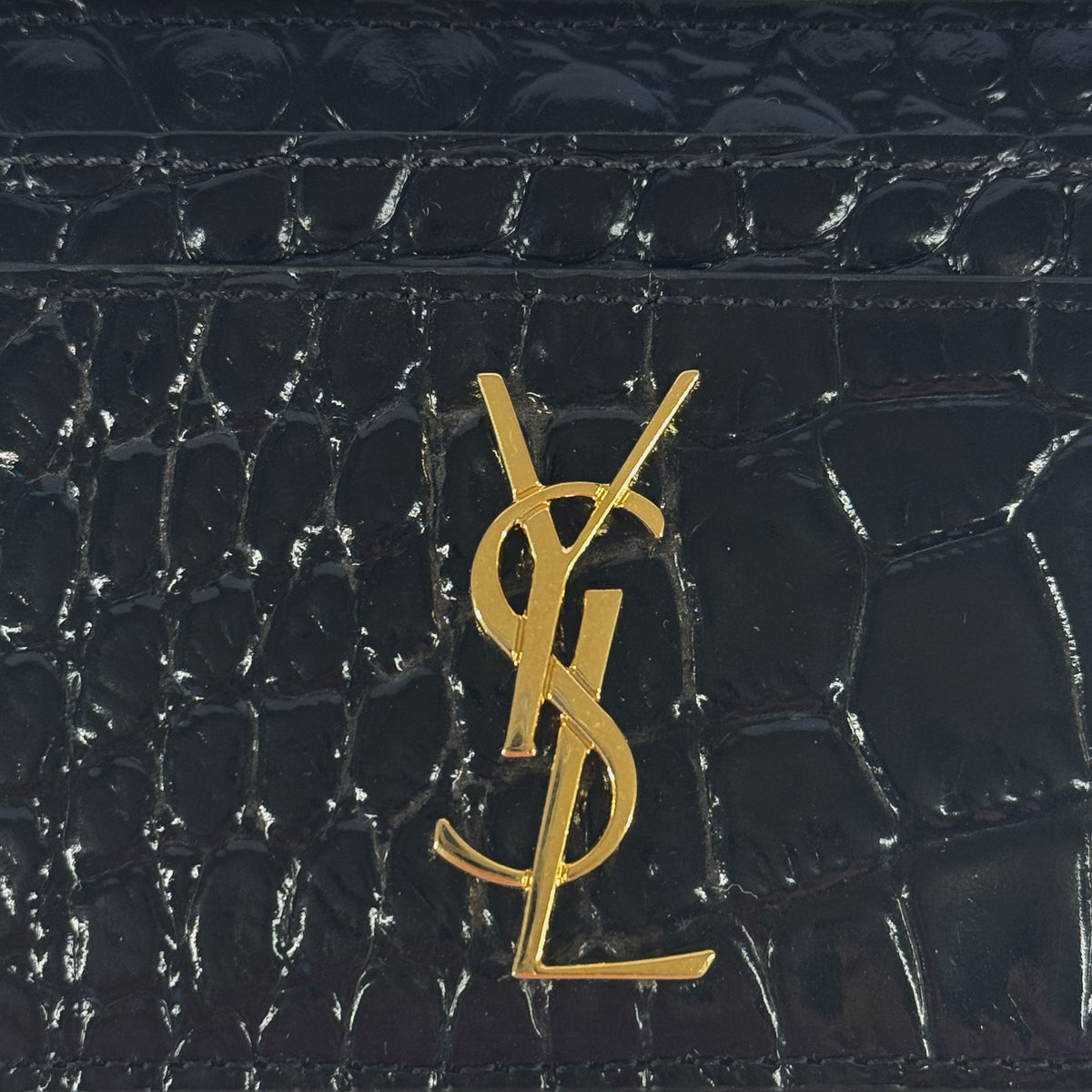 Black crocodile-effect leather wallet with gold YSL logo, curated Pre-loved Luxury by Myluxe in Helsinki.