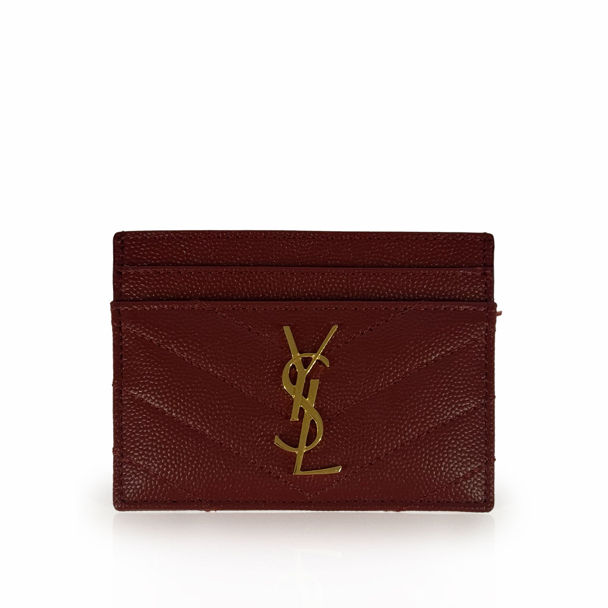 Burgundy pebbled leather Saint Laurent card holder with gold YSL logo, curated Pre-loved Luxury by Myluxe in Helsinki.