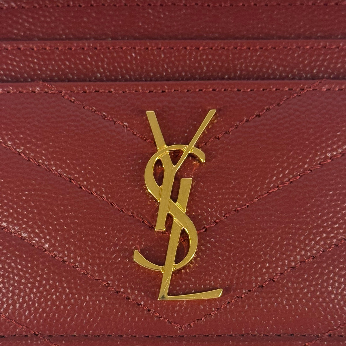 Gold YSL logo on burgundy grained leather, curated Pre-loved Luxury by Myluxe in Helsinki.