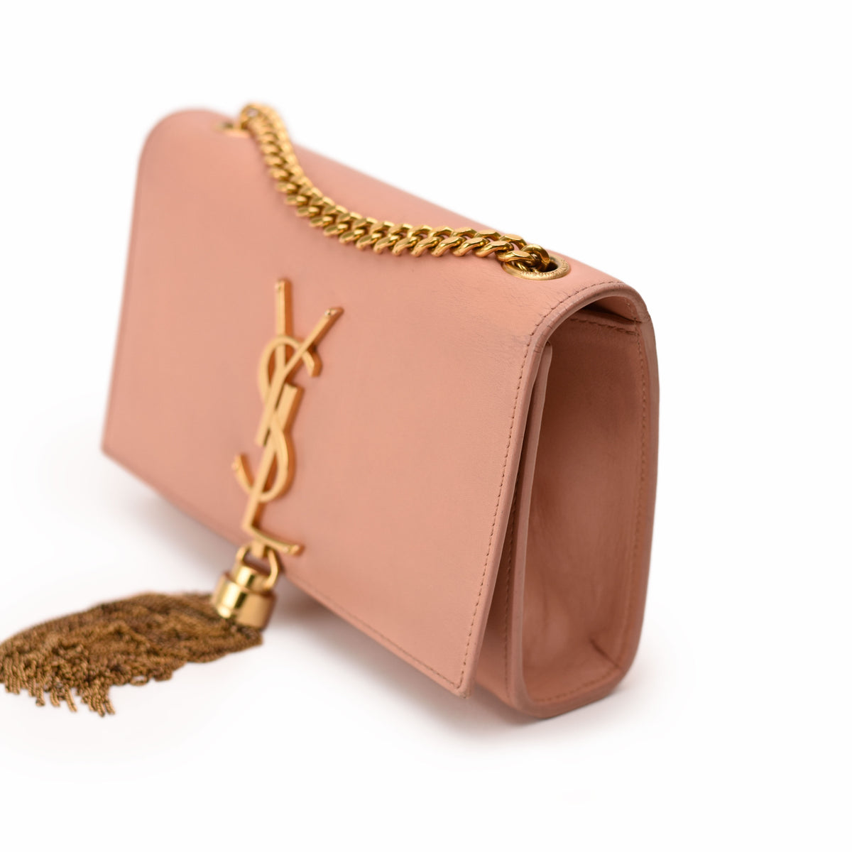 Blush pink leather Yves Saint Laurent clutch with gold YSL logo, chain strap, and tassel. curated Pre-loved Luxury by Myluxe in Helsinki.